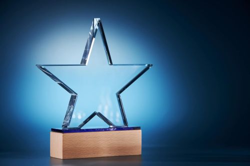 crystal star shape trophy against blue background